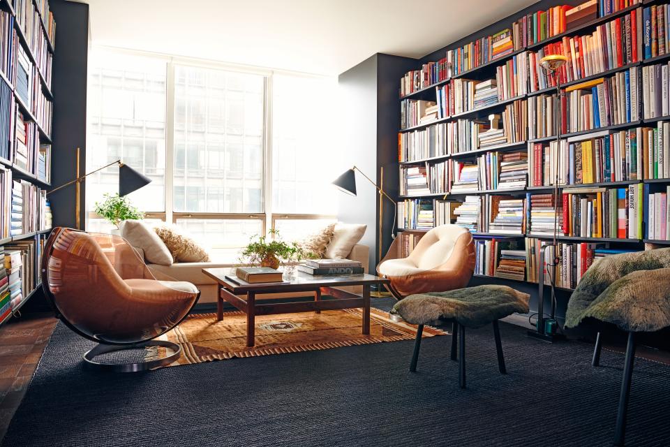 The apartment’s second bedroom was turned into a library packed with books about art, architecture, and photography. Mr. Mann chose an eclectic collection of furnishings, including a custom daybed with contemporary lines, a set of post-modern 1970s chairs by Boris Tabacoff for Mobilier Modulaire Moderne, and a Siirt throw rug from Eastern Anatolia, purchased at Kea Carpets and Kilims.