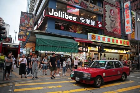 Pedestrians walk outside a Jollibee branch in Mong Kok, Hong Kong