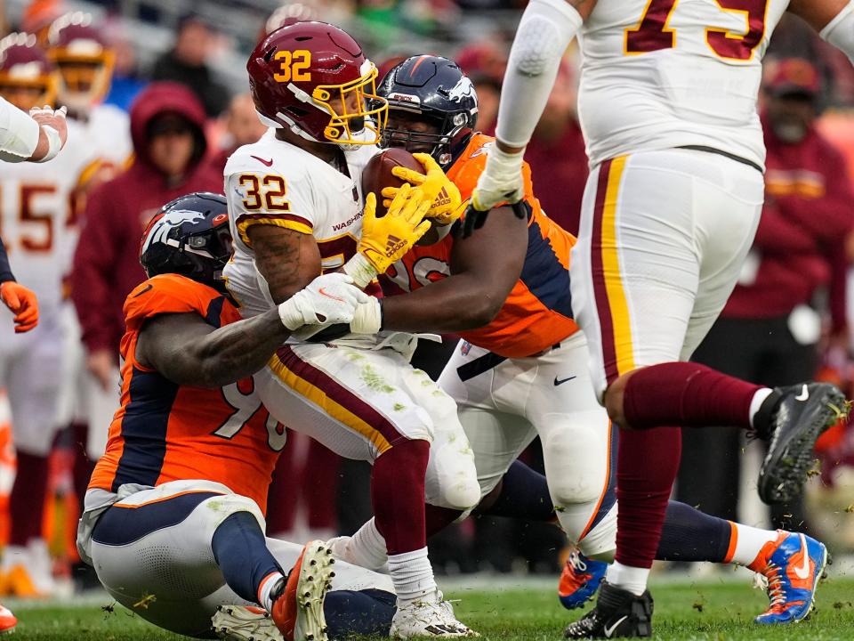 Jaret Patterson completes a carry against the Denver Broncos.