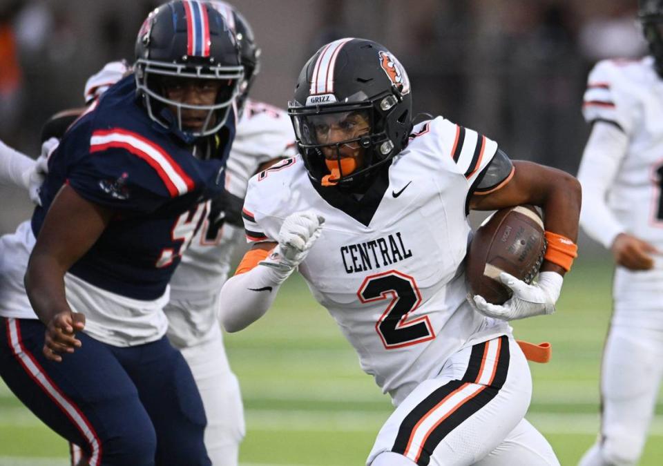 Central High’s Brandon Smith, center carries te ball against Garza High in the opening game of the 2024 season at Koligian Stadium Friday, Aug. 23, 2024 in Fresno.