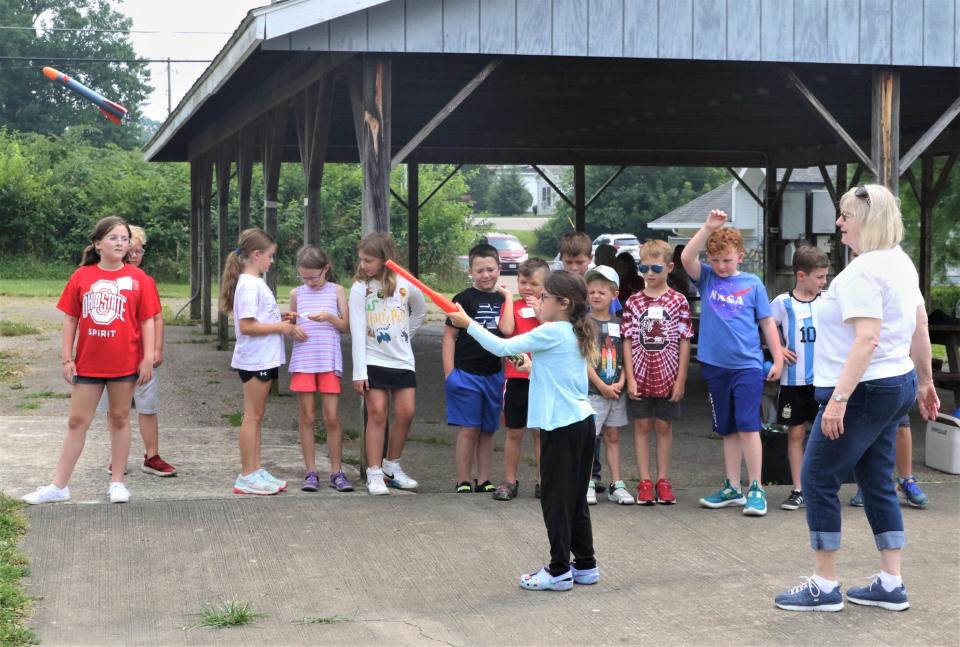 Eva Kosla shoots a rocket during an experiment, which was part of Space Days on Monday at the John and Annie Glenn Museum. This year's theme was All About Rockets, as the youth learned different aspects of how rockets work.