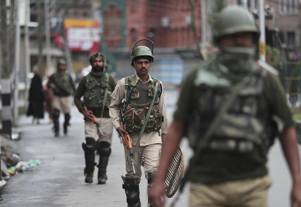 Indian paramilitary soldiers patrol a street in Srinagar, Indian controlled Kashmir, Saturday, Aug. 10, 2019. Authorities enforcing a strict curfew in Indian-administered Kashmir will bring in trucks of essential supplies for an Islamic festival next week, as the divided Himalayan region remained in a lockdown following India's decision to strip it of its constitutional autonomy. The indefinite 24-hour curfew was briefly eased on Friday for weekly Muslim prayers in some parts of Srinagar, the region's main city, but thousands of residents are still forced to stay indoors with shops and most health clinics closed. All communications and the internet remain cut off. (AP Photo/Mukhtar Khan)