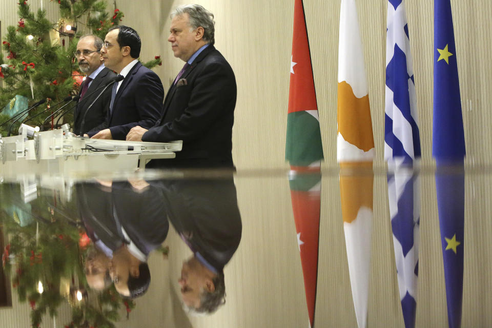 Cypriot foreign minister Nicos Christodoulides, center, Foreign minister of Jordan Ayman Safadi, left, and the Greek Alternate Minister of Foreign Affairs Georgios Katrougalos talk to the media during a press conference after their meeting at the presidential palace in Nicosia, Cyprus, Wednesday, Dec. 19, 2018. The three ministers are meeting in the Cypriot capital to explore ways of strengthening ties on fields as varied as education and entrepreneurship. (AP Photo/Petros Karadjias)