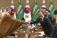 South Korean President Moon Jae-in, right, shakes hands with Saudi Crown Prince Mohammed bin Salman during a meeting at the presidential Blue House, Wednesday, June 26, 2019, in Seoul, South Korea. Bin Salman is visiting South Korea for two days - the first time by an heir to the throne of Saudi Arabia since 1998. (Chung Sung-Jun/Pool Photo via AP)