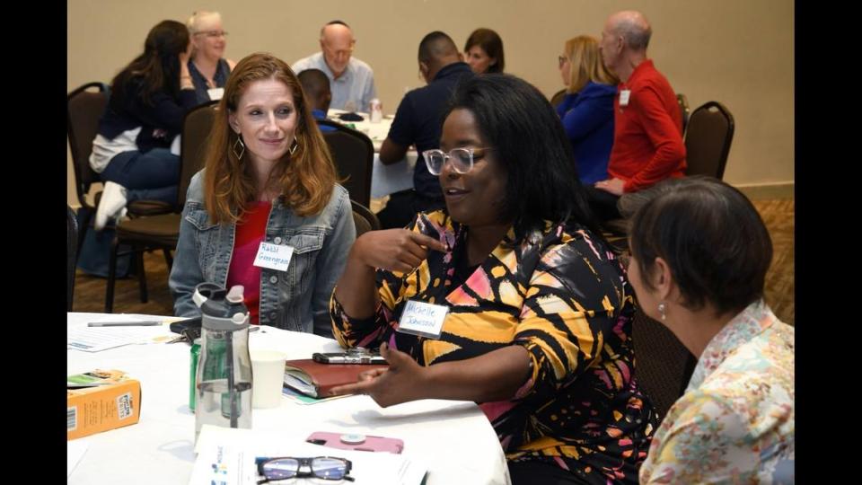 Temple Beth Am Rabbi Rachel Greengrass and Michelle Johnson, Mayor Daniella Levine Cava’s religious outreach liaison discuss ideas with committee members at a community workshop in June.