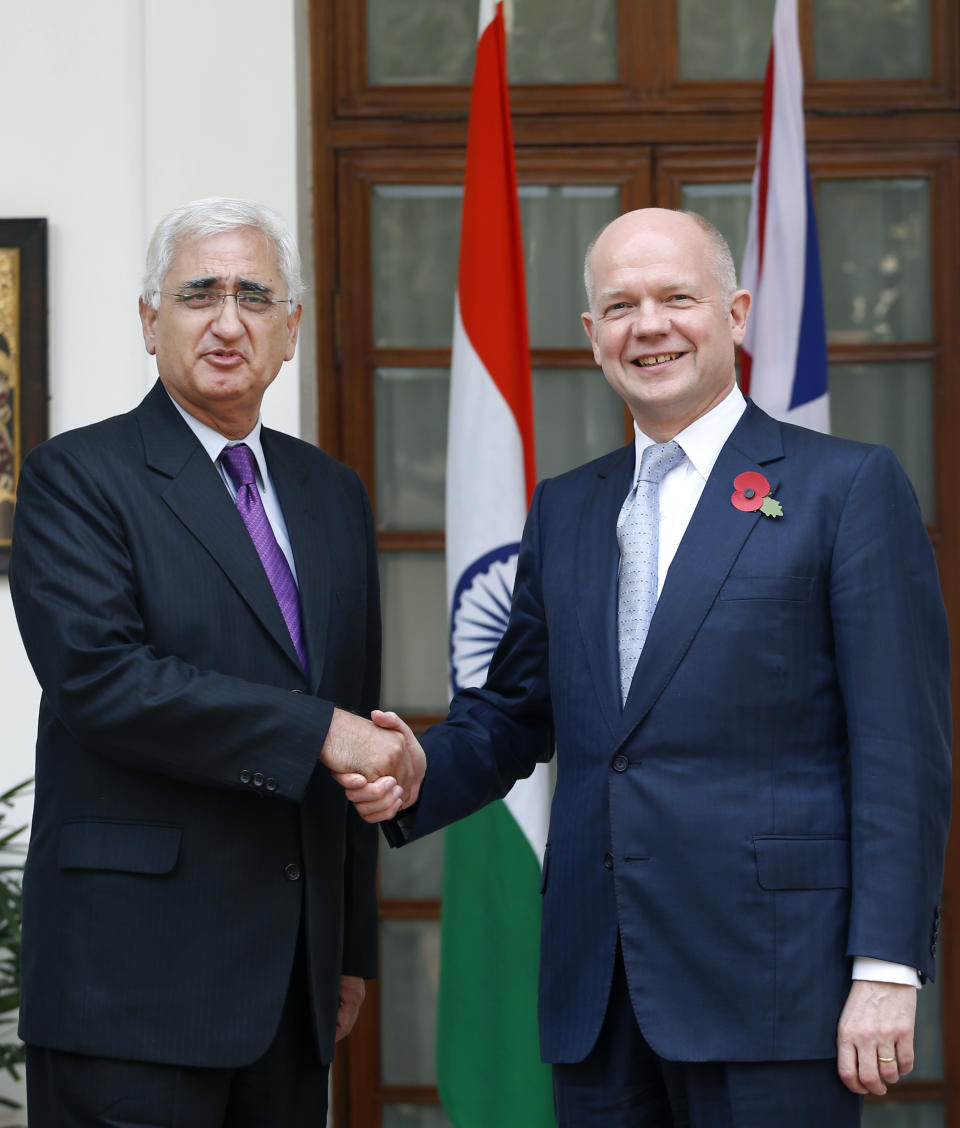 Indian Foreign Minister Salman Khurshid, left, poses for the media with British Foreign Secretary William Hague, before a meeting in New Delhi, India, Thursday, Nov. 8, 2012. Hague is meeting with top officials in the Indian capital to discuss ways to increase trade and investment and to tackle other issues, including terrorism, cyber security and defense. (AP Photo/Saurabh Das)