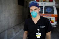 Dennis D'Urso, a resident ER doctor at Jackson Memorial Hospital, poses for a photo during his shift amid an outbreak of the coronavirus disease (COVID-19), in Miami