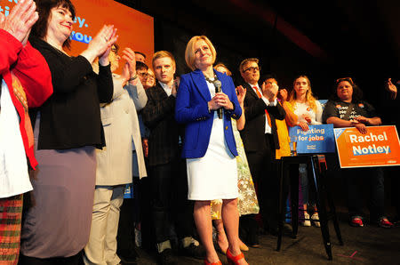 Alberta New Democratic (NDP) leader and Premier Rachel Notley, flanked by her son Ethan and husband Lou Arab, reacts to her loss at her election night party in Edmonton, Alberta, Canada, April, 16, 2019. REUTERS/Candace Elliott