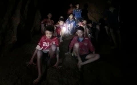 The boys and football coach when they found in the cave - Credit: Tham Luang Rescue Operation Center/AP