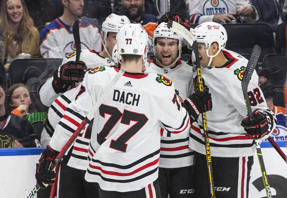 Chicago Blackhawks' Kirby Dach (77), Connor Murphy (5), Brandon Hagel (38) and Caleb Jones (82) celebrate a goal against the Edmonton Oilers during the first period of an NHL hockey game Wednesday, Feb. 9, 2022, in Edmonton, Alberta. (Jason Franson/The Canadian Press via AP)