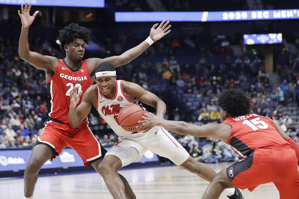 Mississippi's Blake Hinson, center, drives against Georgia's Rayshaun Hammonds (20) and Sahvir Wheeler (15) in the second half of an NCAA college basketball game in the Southeastern Conference Tournament Wednesday, March 11, 2020, in Nashville, Tenn. Georgia won 81-63. (AP Photo/Mark Humphrey)