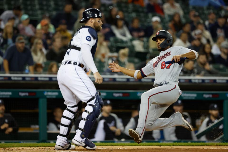 Minnesota Twins shortstop Jermaine Palacios (87) slides in safe at home ahead of the throw to Detroit Tigers catcher Tucker Barnhart (15) in the third inning at Comerica Park.