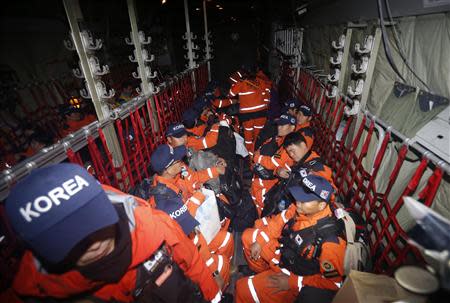 Members of South Korea Disaster Relief Team sit in a South Korean Air Force C-130 transport plane to depart for typhoon affected areas in the Philippines at Seoul military airport in Seongnam, south of Seoul November 15, 2013. REUTERS/Kim Hong-Ji