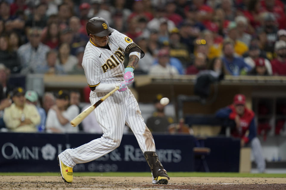 San Diego Padres' Manny Machado hits an RBI single during the fifth inning of the team's baseball game against the St. Louis Cardinals, Tuesday, Sept. 20, 2022, in San Diego. (AP Photo/Gregory Bull)