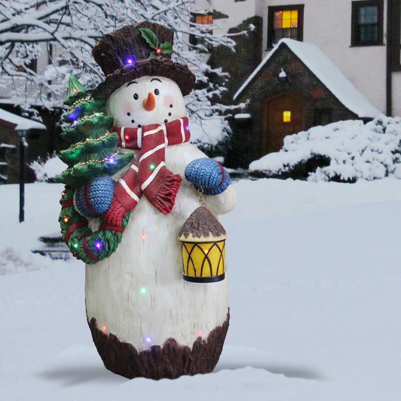 Snowman Holding Christmas Tree Figurine. Image via Wayfair.