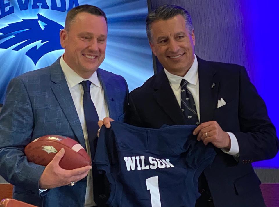 New Nevada head football coach Ken Wilson, left, poses with university president Brian Sandoval after being introduced Friday.