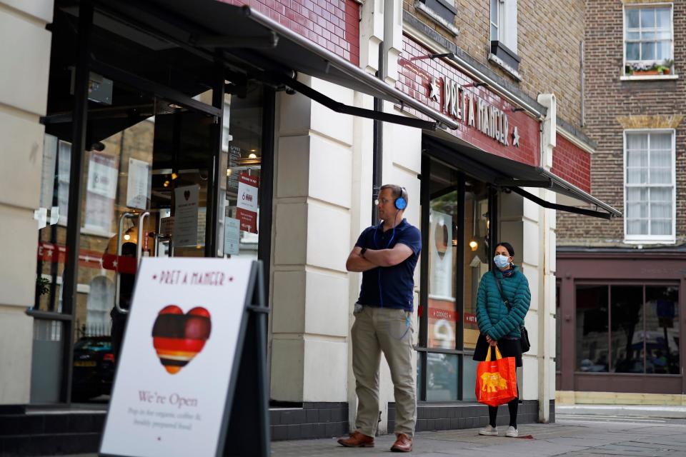 People queue outside a cafe in London (AFP via Getty Images)