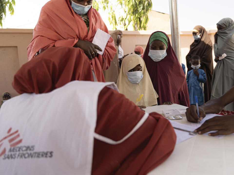 In this handout photo released by MSF, a health worker registers patients in Kano, Nigeria, Monday, Oct. 23, 2023. Authorities in several West African countries are trying to manage their huge diphtheria outbreaks, including in Nigeria where a top health official said Thursday Nov. 23, 2023 that millions are being vaccinated to cover wide gaps in immunity against the disease. (Georg Gassauer, MSF via AP)