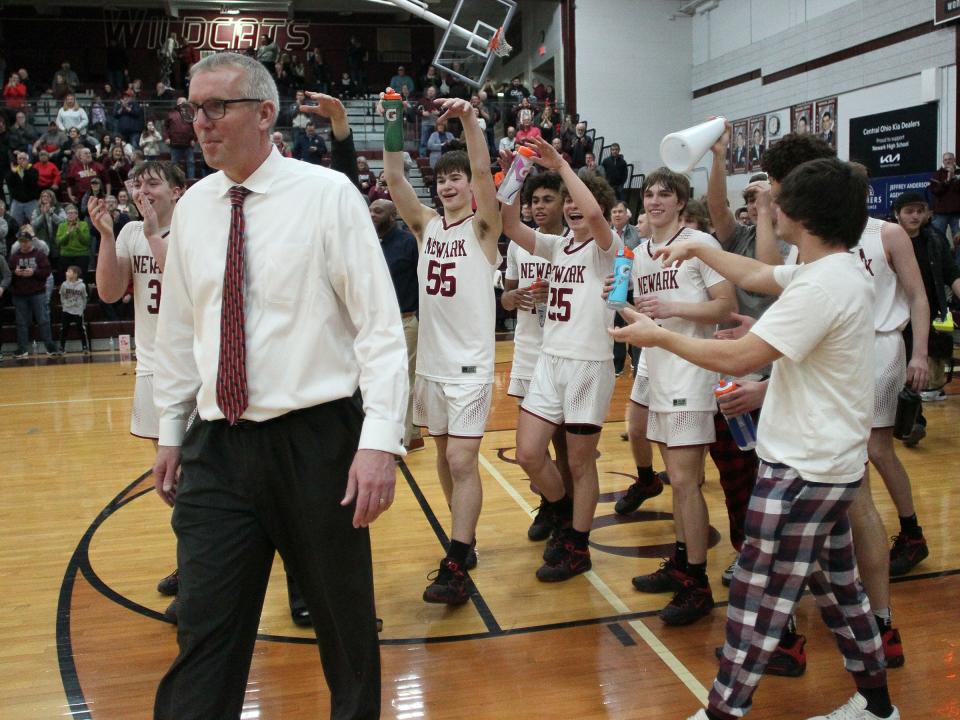 Newark celebrates its 58-36 victory against New Albany, which gave coach Jeff Quackenbush 408 career victories to surpass Gary Walters as the Wildcats' all-time leader, at Jimmy Allen Gymnasium on Friday, Feb. 24, 2023. Newark advanced to play Gahanna in Wednesday's Division I district semifinals.