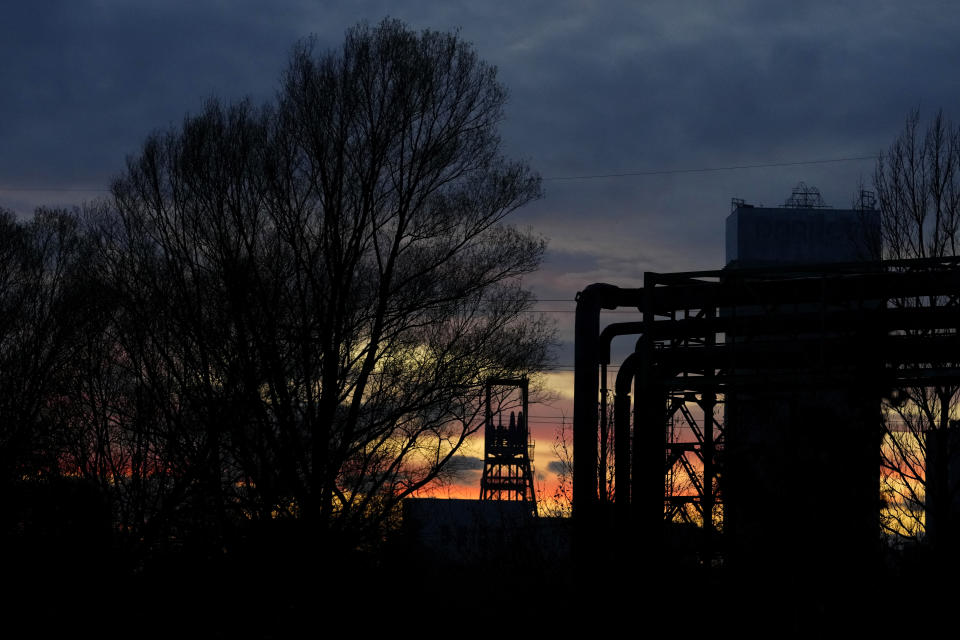 A mining tower of a coal mine is silhouetted against the sunset near Ostrava, Czech Republic, Thursday, Nov. 10, 2022. High energy prices linked to Russia's war in Ukraine have paved the way for coal’s comeback, endangering climate goals and threatening health from increased pollution. (AP Photo/Petr David Josek)