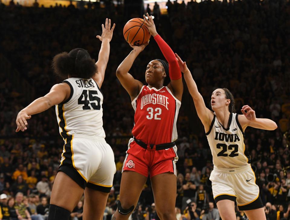 Ohio State forward Cotie McMahon shoots against Iowa's Hannah Stuelke (45) and Caitlin Clark on Sunday.