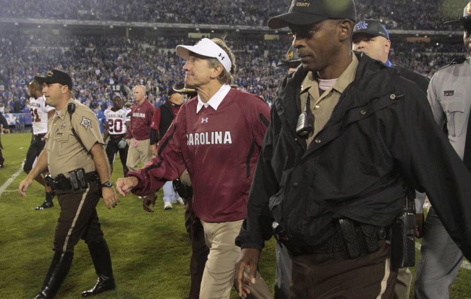 Steve Spurrier walked off the field as Kentucky stormed it after the Wildcats beat South Carolina in 2010. It was UK’s first win over Spurrier in 18 tries.