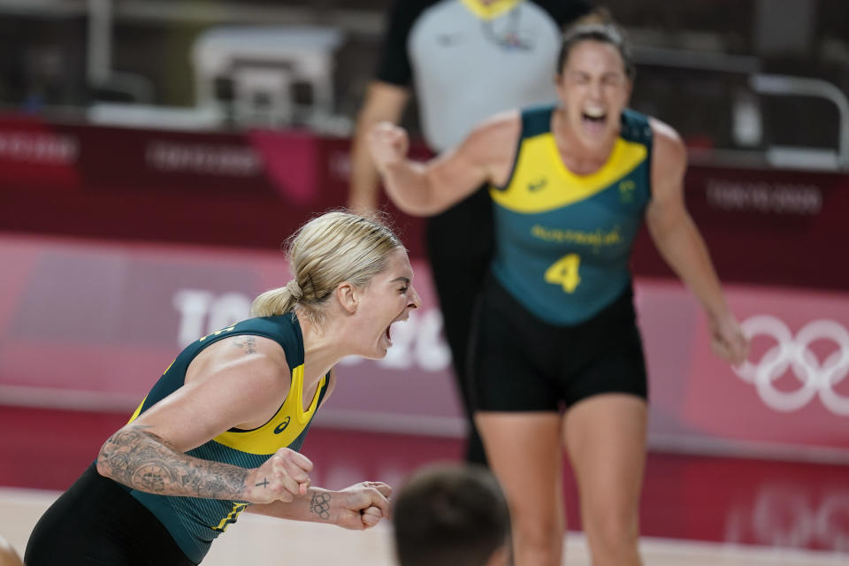 Australia's Cayla George, left, celebrates after making a basket during a women's basketball preliminary round game against Puerto Rico at the 2020 Summer Olympics, Monday, Aug. 2, 2021, in Saitama, Japan. (AP Photo/Charlie Neibergall)