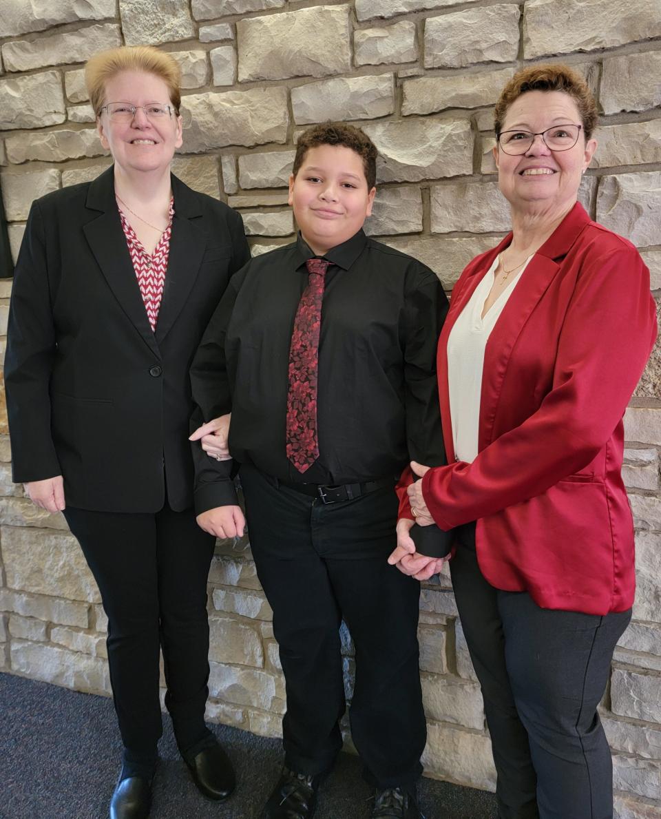 Kate Varnum (left) stands beside her son, Alex Varnum, and wife, Trish Varnum.