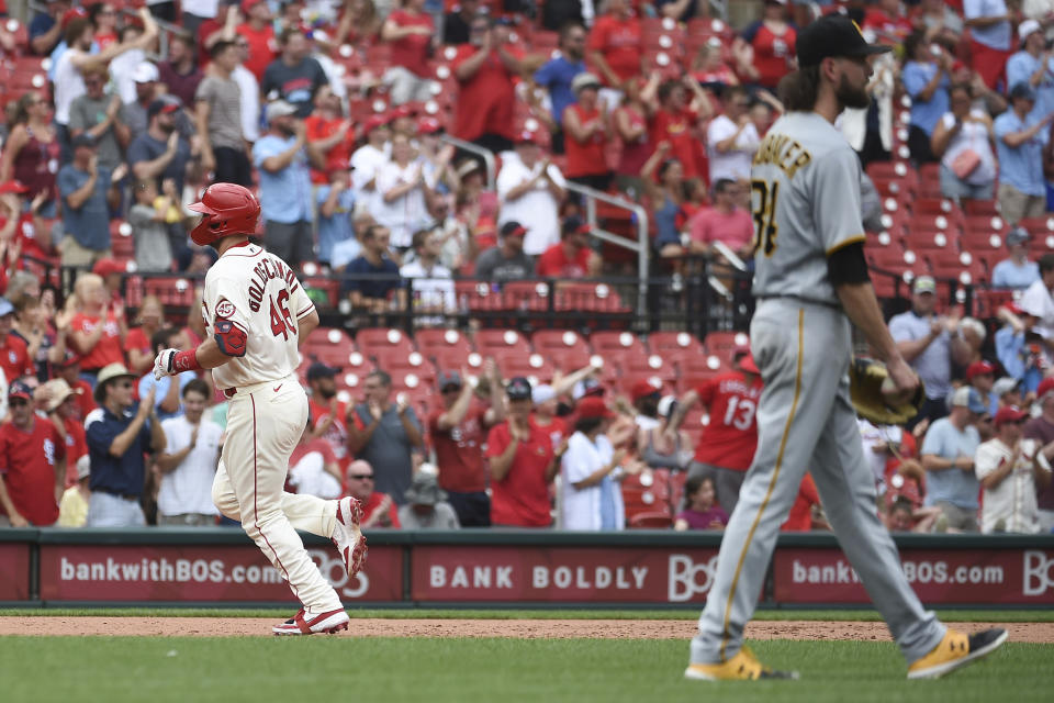 St. Louis Cardinals' Paul Goldschmidt, left, runs after hitting a home run during the fifth inning of a baseball game against the Pittsburgh Pirates, Saturday, June 26, 2021, in St. Louis. (AP Photo/Joe Puetz)