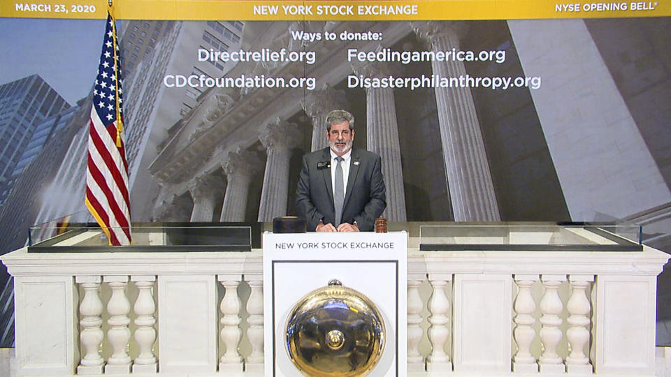 Tom Greene, New York Stock Exchange Vice President of Building Operations, rings the opening bell of the NYSE, Monday, March 23, 2020. Wall Street is wobbling mostly lower in early trading Monday after a bill to provide emergency help to the economy stalled in Congress. (New York Stock Exchange via AP)