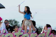 Child actress Xyriel Manabat throws posters to the crowd as the float of the movie, Sisterekas makes its way at the 2012 Metro Manila Film Festival Parade of Stars on 23 December 2012. (Angela Galia/NPPA Images)