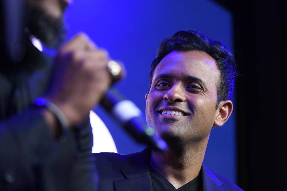 Republican Presidential candidate Vivek Ramaswamy right, listens to former inmate and author Tyrone Muhammad left, during a town hall meeting Friday, May 19, 2023, in Chicago. (AP Photo/Paul Beaty)