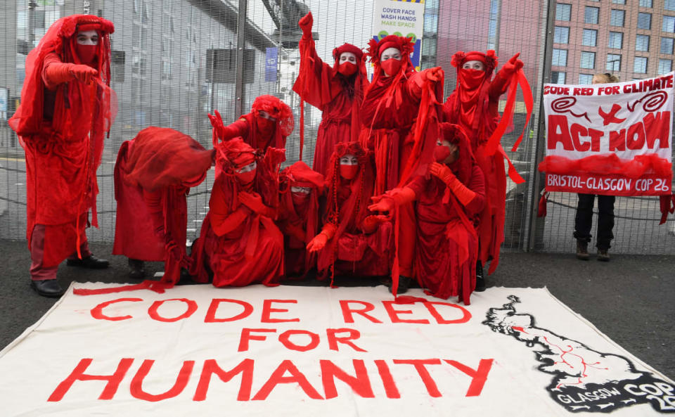 <div class="inline-image__title">1236295695</div> <div class="inline-image__caption"><p>Members of the Red Rebel Brigade—an international performance artist troupe—demonstrate outside the perimeter of the COP26 UN Climate Change Conference.</p></div> <div class="inline-image__credit">Andy Buchanan</div>