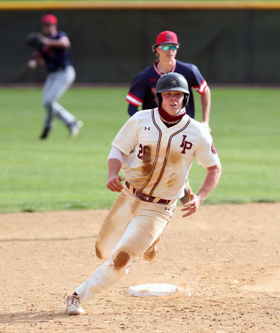 Iona's Jimmy Keenan (26) goes from first to third on a single against Stepinac during baseball action at Iona Prep in New Rochelle May 12, 2021. Iona won the game 2-1.