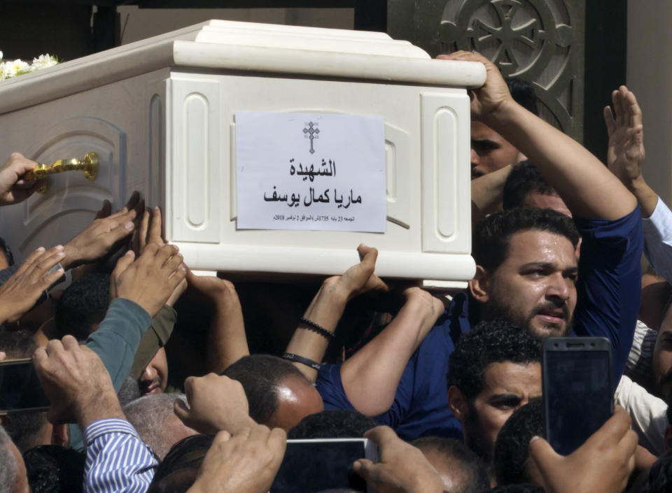 FILE - In this Saturday, Nov. 3, 2018 file photo, relatives and friends carry the coffin of, Maria Kamal, who was killed in an attack on a bus Saturday, after funeral services at the Church of Great Martyr Prince Tadros, in Minya, Egypt. Egypt says security forces have killed 19 militants in a shootout, including the gunmen suspected of killing seven Christians in an attack on pilgrims traveling to a remote monastery on Saturday. The Interior Ministry said Sunday the militants were tracked to a desert hideout west of the central Minya province, where Friday's attack took place. (AP Photo/Amr Nabil, File)