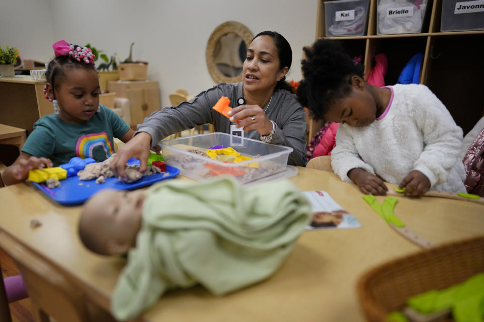 Teacher Sehila Jiminez works with children during a preschool class at the Life Learning Center - Head Start, in Cincinnati, Tuesday, Nov. 21, 2023. A new plan from the Biden administration could significantly increase salaries for hundreds of low-paid early childhood teachers caring for the country's poorest children but might also force some centers to cut enrollment. (AP Photo/Carolyn Kaster)