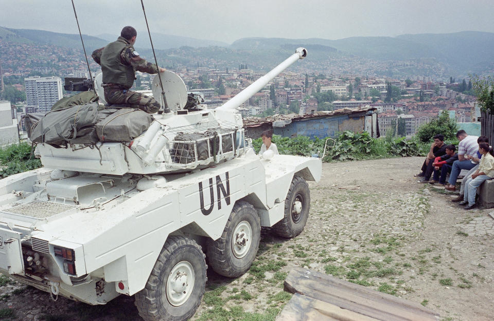 FILE - A French UN peacekeeper sits atop a light tank, its canon pointing towards Serbs lines from a hilltop overlooking Sarajevo, on May 28, 1995. The United Nations Peacekeeping efforts is under resourced as its $5.5 billion budget for worldwide operations is less than the New York Police Department's $6.1 billion budget, even though it has 30,000 more personnel, the UN Under-Secretary General, Peace Operations Jean-Pierre Lacroix said Wednesday, Dec. 6, 2023 at a two-day UN Peacekeeping Ministerial Meeting in Accra, Ghana. (AP Photo/Jerome Delay, File)