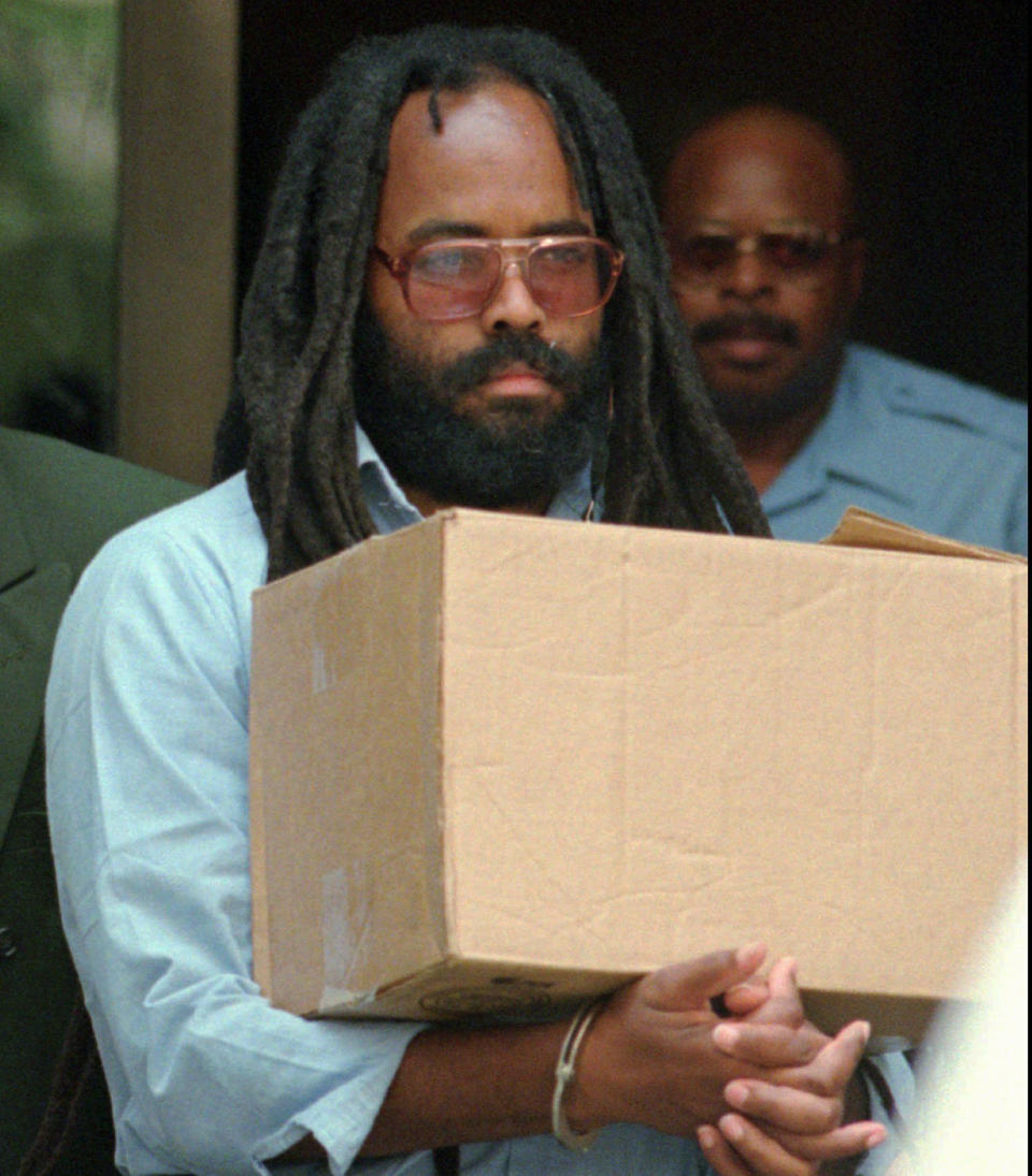 FILE - In this July 12, 1995 file photo, Mumia Abu-Jamal leaves Philadelphia's City Hall after a hearing. Former death row inmate Abu-Jamal is back in court Thursday, Aug. 30, 2018, requesting that his failed appeals attempts be vacated, so he can once again appeal his case. The former Black Panther spent 29 years on death row following his conviction in the 1981 murder of Philadelphia police Officer Daniel Faulkner. (AP Photo/Chris Gardner, File)