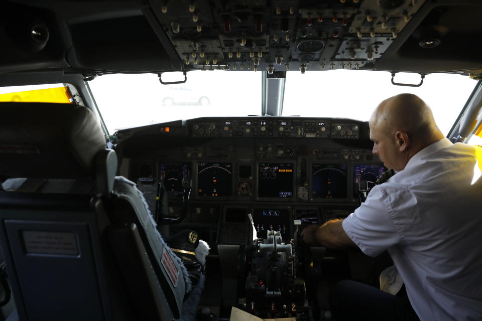 A member of the flight crew sits in the cockpit of the Israeli flag carrier El Al's airliner which will carry Israeli and U.S. delegations to Abu Dhabi for talks meant to put final touches on the normalization deal between the United Arab Emirates and Israel, at Ben Gurion International Airport, near Tel Aviv, Israel Monday, Aug. 31, 2020.(Nir Elias/Pool Photo via AP)