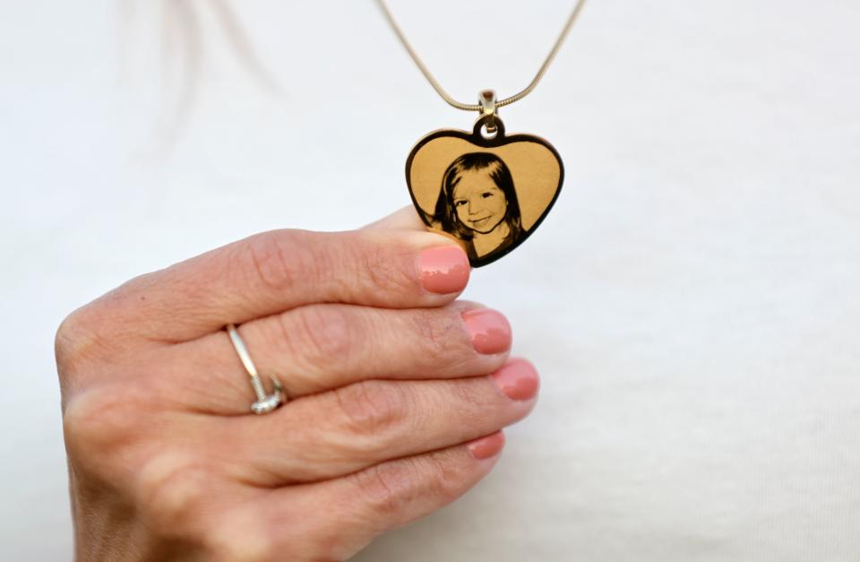 Catrina Nelson shows the necklace she wears with a photo of her daughter Charlee Nelson, at Memorial Holladay Cemetery in Holladay on Friday, June 30, 2023. Charlee died at age 6 of Batten disease, just days after Charlee’s Law was passed in her name, making CBD oil legal in Utah. Charlee never got the chance to try it herself. | Kristin Murphy, Deseret News