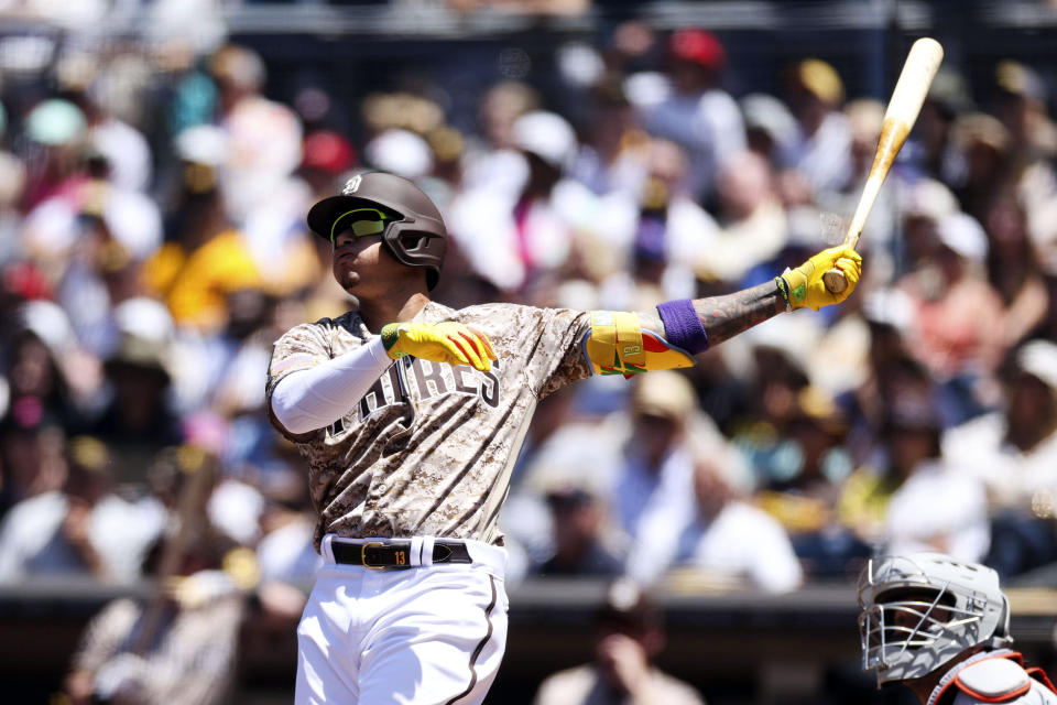 San Diego Padres' Manny Machado, left, watches his three-run home run as New York Mets' Francisco Alvarez looks on in the first inning of a baseball game Sunday, July 9, 2023, in San Diego. (AP Photo/Derrick Tuskan)