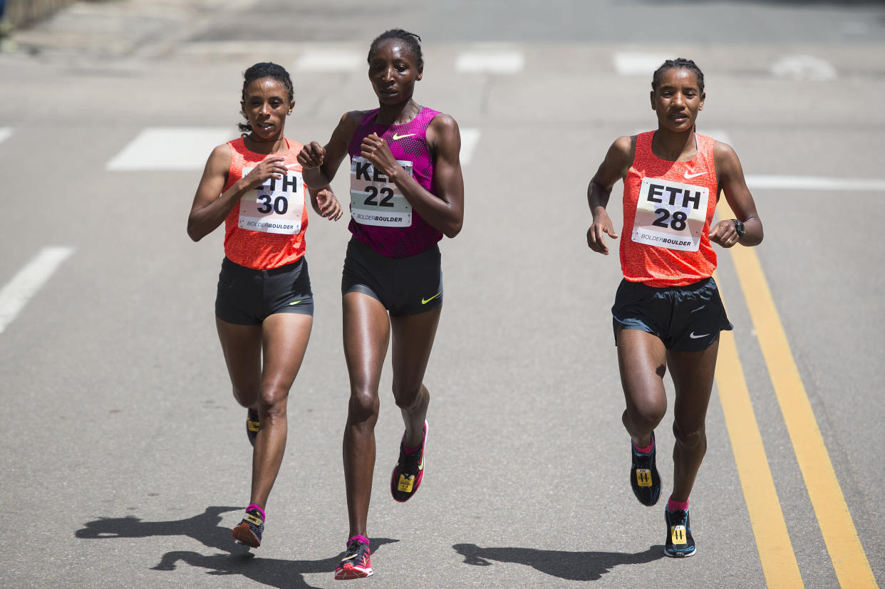 BOULDER, CO - MAY 25: From left, Meskerem Assefa #30, Risper Gesabwa #22 and Amane Gobena #28 run during the women's elite race at the 2015 Bolder Boulder  10K on May 25, 2015, in Boulder, Colorado. (Photo by Daniel Petty, The Denver Post)