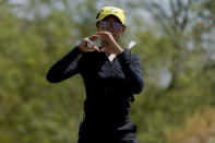 FILE - Oregon golfer Tze-Han Lin gestures to teammates on the first green during the NCAA college women's golf championship title match against Stanford, at Grayhawk Golf Club in Scottsdale, Ariz., Wednesday, May 25, 2022. Tze-Han Lin, like many other international athletes playing college sports in the United States, had little sense of Title IX when they were teenagers. But the federal law has opened the door for thousands of female athletes to get an American education and a shot at a career. (AP Photo/Matt York, File)
