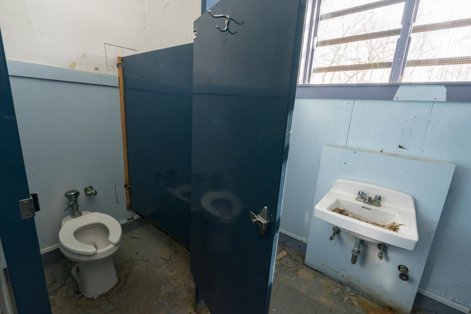 A broken toilet and a backed up sink are just some of the repairs needed in the bathroom of the woman's changing area at the Spratt Park pool house in Poughkeepsie, N.Y., Tuesday, Jan. 25, 2022. Poughkeepsie was rated by the New York comptroller as the state’s most financially stressed community in 2020. The more than $20 million it is getting from the American Rescue Plan cannot be used to wipe out the deficit, but the city plans to make major improvements to parks and swimming pools, including a complete rebuild of a run-down bathhouse that has been relying on portable toilets. (AP Photo/Mary Altaffer)