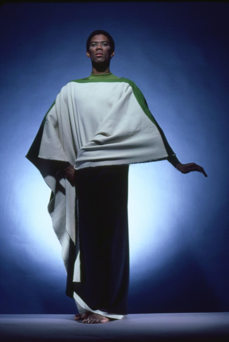 A dancer wearing a draped white and green costume.