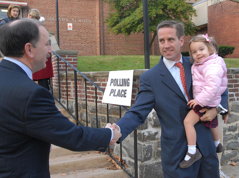 Delaware Democratic Attorney General candidate Beau Biden, holding his daughter Natalie, greets Gary Linarducci after placing his vote in Wilmington, Del., Tuesday, Nov. 7, 2006  (AP Photo/Pat Crowe II)