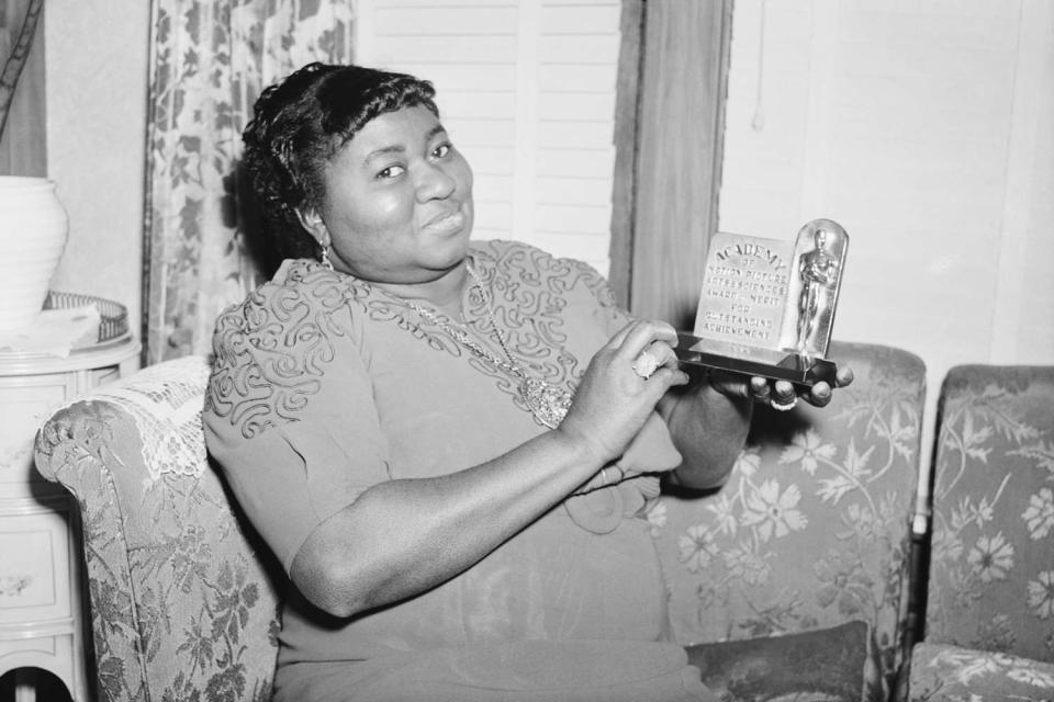 <p>Getty</p> Hattie McDaniel with her Oscar on March 2, 1940, in Los Angeles
