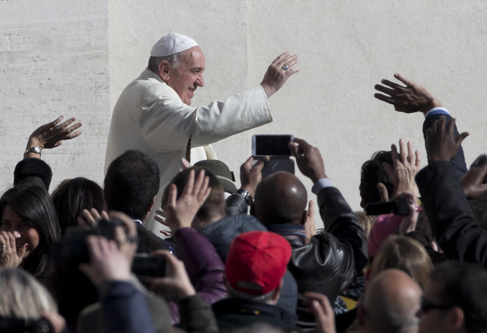 Pope Francis greets the crowd as he arrives for his weekly general audience in St. Peter's Square at the Vatican, Wednesday, March 5, 2014. The pontiff says he finds the hype that is increasingly surrounding him "offensive." In an interview with Italian daily Corriere della Sera, Francis said he doesn't appreciate the myth-making that has seen him depicted as a "Superpope" who sneaks out at night to feed the poor. On Wednesday, a new Italian weekly hit newsstands — a gossip magazine devoted entirely to the pope. Francis said: "The pope is a man who laughs, cries, sleeps calmly and has friends like everyone else. A normal person." (AP Photo/Alessandra Tarantino)