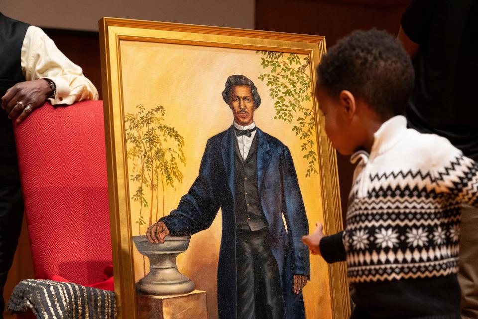 A young descendant of John R. Blackburn walks past a new painted portrait of John R. Blackburn, the college’s first black student, during a series of events honoring his life in Salter Hall at the Fine Arts Center Monday, Feb. 5, 2024, at Wabash College in Crawfordsville, Indiana.