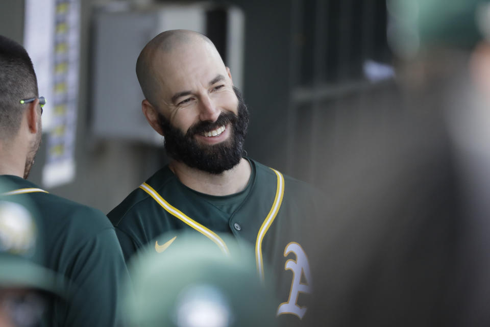 Oakland Athletics' Mike Fiers smiles in the dugout during the second inning of a spring training baseball game against the San Francisco Giants, Sunday, Feb. 23, 2020, in Mesa, Ariz. (AP Photo/Darron Cummings)